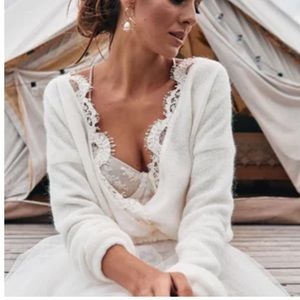 Bridal sweater knitted with lace and a liner. Cinched at the waste, long sleeve